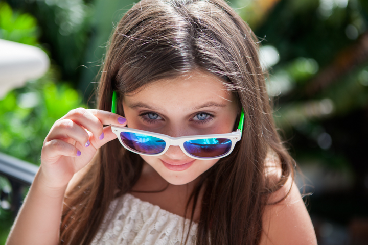 Child playing with sunglasses