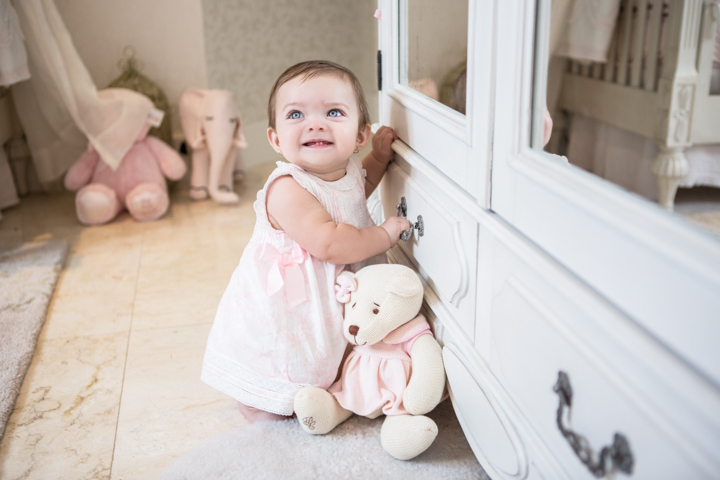 Child standing beside a cabinet