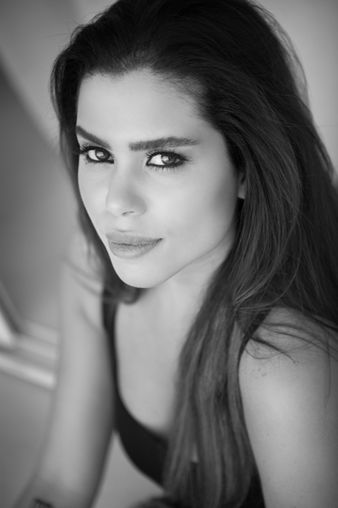 A close portrait of a woman turning toward the camera.