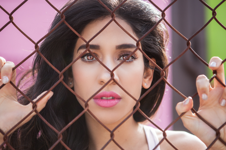 Woman beside a fence