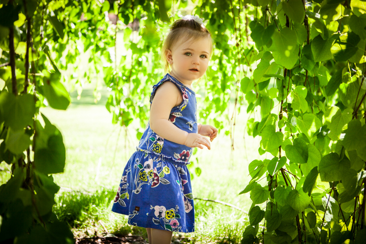 Child among green leaves