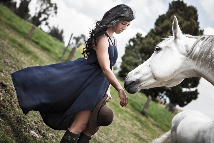 Woman beside a white horse