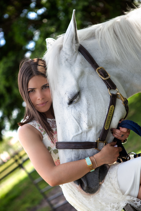 Woman embracing a white horse