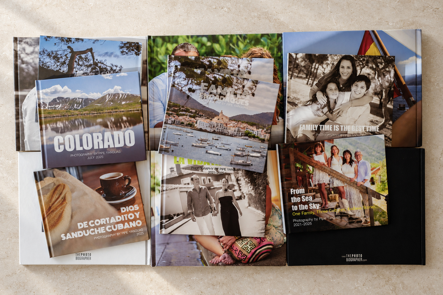 A collection of PHOTObiography books with covers showing travel, families, and portraits.